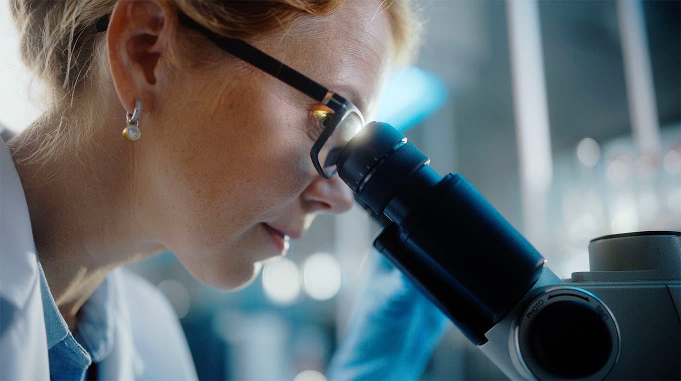 Scientist looking through a microscope